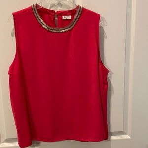 Sleeveless top with silver embellishments.